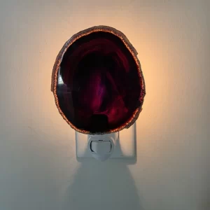 Premier Halite Agate Night Light plugged in and glowing – Natural polished stone slice with deep purple bands – Warm plug-in lamp for home decor