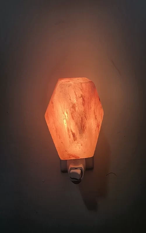 Top-Down View of Illuminated Premier Halite Diamond Night Light – Close-Up of Hexagonal Pink Salt Crystal Texture with Warm Amber Glow in Dark Room – Plug-In Himalayan Salt Lamp for Bedroom and Hallway USA Canada