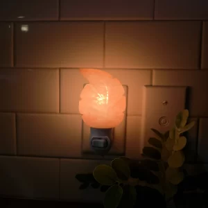 Himalayan Salt Leaf Night Light glowing warm orange – Plug-in pink salt lamp shaped like a leaf by Premier Halite – Soft light for bedroom, nursery, or hallway – USA and Canada