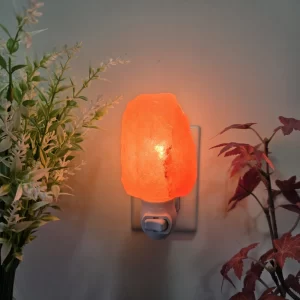 Natural Night Light plugged in and glowing – Rough-cut pink Himalayan salt with warm light – Simple plug-in lamp for home decor by Premier Halite